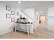 Hallway features a rustic table and decor by the staircase with carpeted floor at 648 Bloom Ter, Davenport, FL 33836