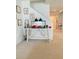 Hallway features a rustic table and decor by the staircase with carpeted floor at 648 Bloom Ter, Davenport, FL 33836