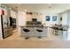 Modern kitchen boasts stainless steel appliances, granite counters, an island with seating, and an adjacent dining table at 648 Bloom Ter, Davenport, FL 33836
