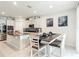 Bright kitchen with stainless steel appliances, granite countertops, large island, and dining area perfect for entertaining at 648 Bloom Ter, Davenport, FL 33836