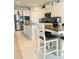 Well-equipped kitchen featuring stainless steel appliances, granite countertops, an island, and a dining area at 648 Bloom Ter, Davenport, FL 33836