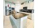 Gourmet kitchen boasts a large island, granite countertops, stainless steel appliances, and stylish backsplash at 648 Bloom Ter, Davenport, FL 33836