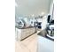 Spacious eat-in kitchen with stainless steel appliances, granite countertops, kitchen island, and tile flooring at 648 Bloom Ter, Davenport, FL 33836