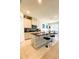 Bright kitchen features white cabinets, granite counters, tile backsplash, and large island with bar seating and adjacent dining area at 648 Bloom Ter, Davenport, FL 33836