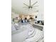 Spacious living room with gray sofas, a large ceiling fan, and an open floor plan at 648 Bloom Ter, Davenport, FL 33836