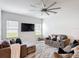 Comfortable living room featuring plush sofas, a large TV, and ample natural light at 648 Bloom Ter, Davenport, FL 33836