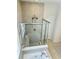 Modern bathroom with glass shower doors and dual shower heads, creating a spa-like experience at 648 Bloom Ter, Davenport, FL 33836