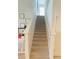 Carpeted stairway leading upstairs, featuring neutral tones and clean lines at 648 Bloom Ter, Davenport, FL 33836