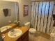 Bathroom featuring a white toilet, vanity, shower with tree-patterned curtain and an embellished framed picture at 705 Gran Bahama Blvd # 705, Davenport, FL 33897