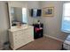 Bedroom with a dresser, TV, and window, offering a comfortable and functional space at 705 Gran Bahama Blvd # 705, Davenport, FL 33897