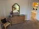 Bedroom with a wicker dresser and mirror reflecting a bed; the doorway leads to a view of the kitchen at 705 Gran Bahama Blvd # 705, Davenport, FL 33897