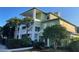 Exterior of a 3-story building with green wood siding, white railings and stairs, and well-manicured landscaping at 705 Gran Bahama Blvd # 705, Davenport, FL 33897