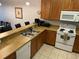 Kitchen features wooden cabinets, white appliances, and a breakfast bar with seating at 705 Gran Bahama Blvd # 705, Davenport, FL 33897