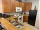 The kitchen features light wood cabinetry, essential appliances and breakfast bar at 705 Gran Bahama Blvd # 705, Davenport, FL 33897