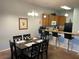 Kitchen with wooden cabinets, bar seating, and open layout to the dining area at 705 Gran Bahama Blvd # 705, Davenport, FL 33897