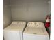 Convenient laundry room with washer, dryer, shelf and fire extinguisher at 705 Gran Bahama Blvd # 705, Davenport, FL 33897