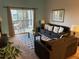 Bright living room featuring a balcony, comfortable seating, and stylish decor for relaxation and socializing at 705 Gran Bahama Blvd # 705, Davenport, FL 33897