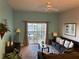 Cozy living room featuring a ceiling fan, comfortable seating, and sliding glass doors to the patio at 705 Gran Bahama Blvd # 705, Davenport, FL 33897