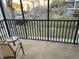 Screened patio with a small outdoor table and one chair overlooking greenery at 705 Gran Bahama Blvd # 705, Davenport, FL 33897