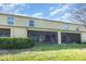 Home's backyard with covered patio, lush lawn, and potential for outdoor living at 380 Arbor Lakes Dr, Davenport, FL 33896