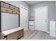 Inviting entryway featuring light wood floors, bench seating, and decorative coat hooks at 380 Arbor Lakes Dr, Davenport, FL 33896