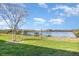 Picturesque lake view with grassy shoreline and bright blue sky in a tranquil setting at 380 Arbor Lakes Dr, Davenport, FL 33896