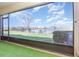 Enclosed lanai overlooking a serene lake and lush green landscape on a beautiful day at 380 Arbor Lakes Dr, Davenport, FL 33896