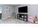 Living room with a large TV, rocking chair, and a view of the backyard at 380 Arbor Lakes Dr, Davenport, FL 33896