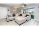 Cozy living room with a gray sectional couch, ceiling fan, and sliding glass door to the backyard at 380 Arbor Lakes Dr, Davenport, FL 33896