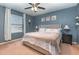 Comfortable main bedroom with a tufted headboard, ceiling fan, and plenty of natural light at 380 Arbor Lakes Dr, Davenport, FL 33896