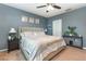 Spacious main bedroom featuring a plush bed, ceiling fan, and stylish decor at 380 Arbor Lakes Dr, Davenport, FL 33896