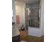 Well-lit bathroom featuring a glass-enclosed shower and wood-look flooring at 512 Central Ridge Ln, Frostproof, FL 33843