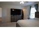Bedroom with a TV, dresser, and walk-in closet at 512 Central Ridge Ln, Frostproof, FL 33843