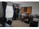 Bedroom features a bulletin board, natural light, and neutral colored carpet at 512 Central Ridge Ln, Frostproof, FL 33843