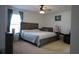 Spacious bedroom featuring a large bed, nightstand, and neutral carpet at 512 Central Ridge Ln, Frostproof, FL 33843