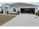 Charming single-story home featuring a wide driveway and attached two-car garage at 512 Central Ridge Ln, Frostproof, FL 33843