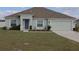 Charming single Gathering home featuring a well manicured lawn, and a two car garage at 512 Central Ridge Ln, Frostproof, FL 33843