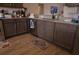 Kitchen featuring dark cabinets, granite countertops, stainless steel appliances, and hardwood floors at 512 Central Ridge Ln, Frostproof, FL 33843