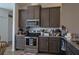 Kitchen featuring dark cabinets, stainless steel appliances, and granite countertops at 512 Central Ridge Ln, Frostproof, FL 33843