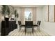 Stylish dining area with a round table, sleek black chairs, textured rug, and minimalist decor at 764 Osprey Roost Dr, Lakeland, FL 33801