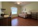 Bedroom featuring a daybed, ceiling fan, and wood laminate flooring at 992 Davit Pl, The Villages, FL 32162