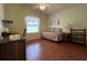 Bedroom with a trundle bed and hardwood floors at 992 Davit Pl, The Villages, FL 32162