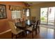 Dining area with a chandelier, a window, a table with seating for six and access to the outdoor patio at 992 Davit Pl, The Villages, FL 32162