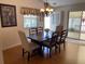 Elegant dining room featuring hardwood floors, a chandelier, and seating for six at 992 Davit Pl, The Villages, FL 32162