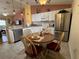 Bright, eat-in kitchen featuring granite countertops, stainless steel appliances, and a casual dining area at 992 Davit Pl, The Villages, FL 32162