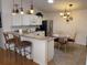 Modern kitchen featuring a breakfast bar, stainless steel appliances, and stylish pendant lighting at 992 Davit Pl, The Villages, FL 32162