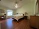 Spacious main bedroom featuring high ceilings, hardwood floors, and comfortable furnishings at 992 Davit Pl, The Villages, FL 32162