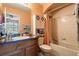 Bathroom with a combined tub and shower featuring peach-colored walls, and a sink at 12313 Citruswood Dr, Orlando, FL 32832