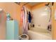 Bathroom featuring a combined bathtub and shower with white tiled wall surround, shower curtain and toilet at 12313 Citruswood Dr, Orlando, FL 32832