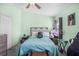Comfortable bedroom featuring a ceiling fan, a double bed with blue bedspread and lots of stuffed animals at 12313 Citruswood Dr, Orlando, FL 32832
